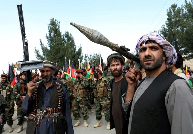 Armed men attend a gathering to announce their support for Afghan security forces and that they are ready to fight against the Taliban, on the outskirts of Kabul, Afghanistan June 23, 2021. PHOTO: REUTERS