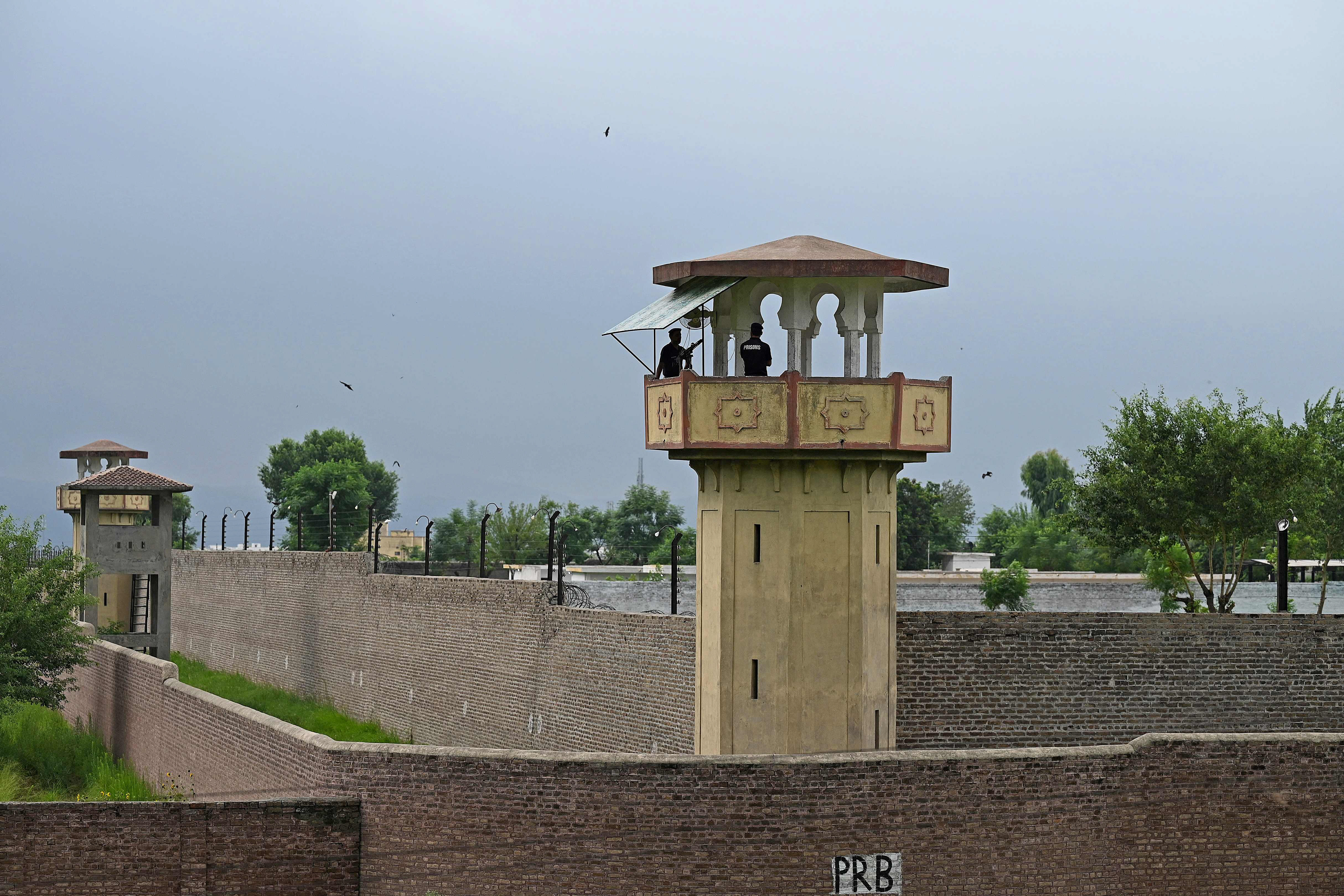 policemen stand at a watch tower of the attock jail where former prime minister imran khan is being held photo afp