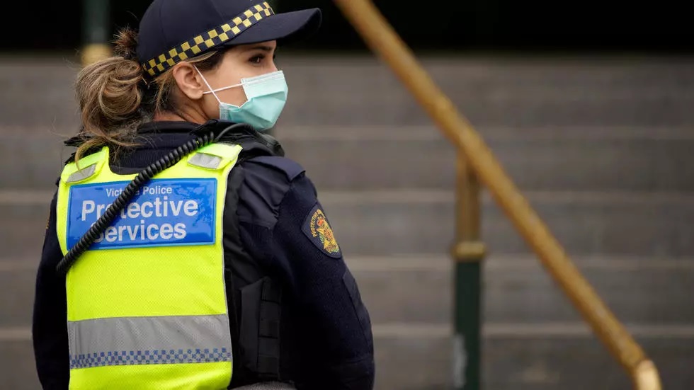 a protective services officer wearing a face mask patrols flinders street station in melbourne after it became the first city in australia to enforce mask wearing in public as part of efforts to curb a resurgence of the coronavirus disease photo afp