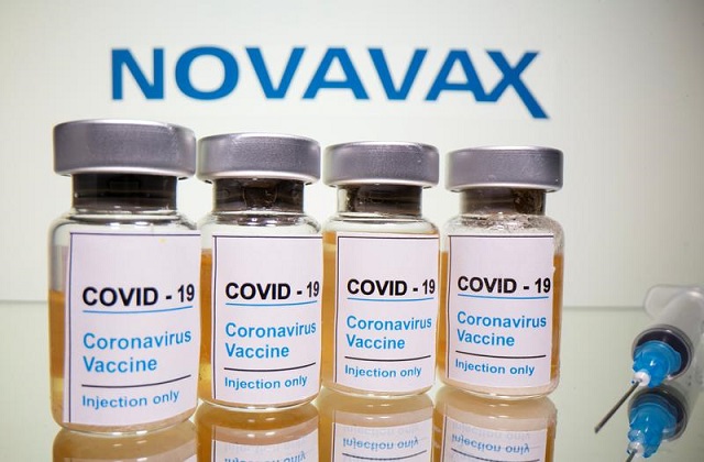 vials with a sticker reading covid 19 coronavirus vaccine injection only and a medical syringe are seen in front of a displayed novavax logo in this illustration taken october 31 2020 photo reuters