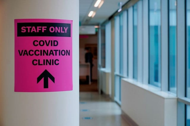 a sign for a covid 19 vaccination clinic is seen as high risk workers receive the first vaccines in the state of victoria s rollout of the program in melbourne australia february 22 2021 photo reuters
