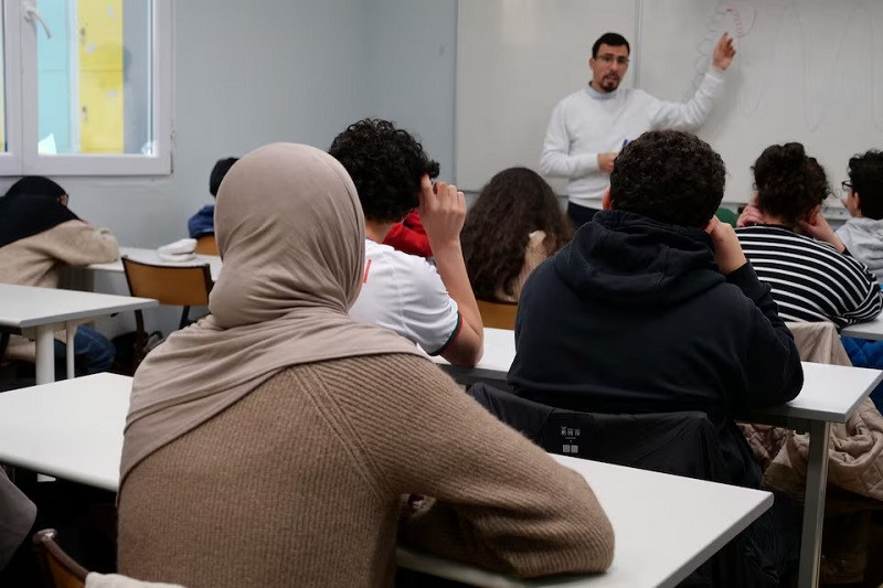 Middle school students listen to teacher Ilyas Laarej during an Islamic ethics class at the Averroes school, in Lille, France, March 19, 2024. PHOTO: REUTERS