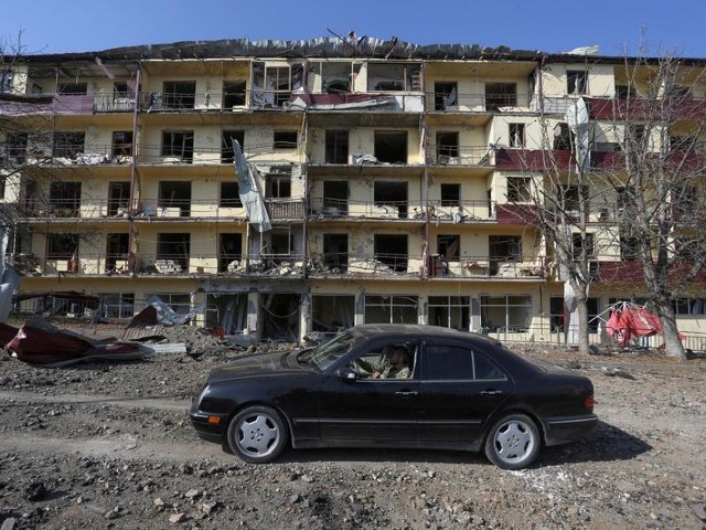 a man drives a car past a damaged building following shelling in the town of shushi shusha in the course of a military conflict over the breakaway region of nagorno karabakh october 29 2020 photo reuters file