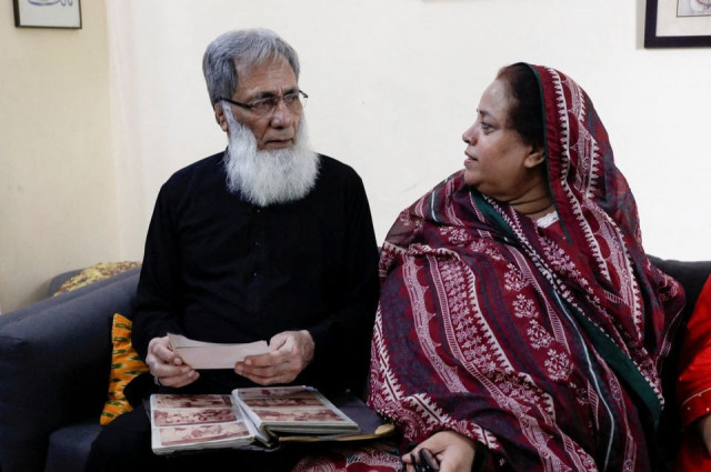 ali hassan baqai 76 whose family was divided by the partition speaks with his wife shaistan ali as they go through the family picture album at home in karachi photo reuters
