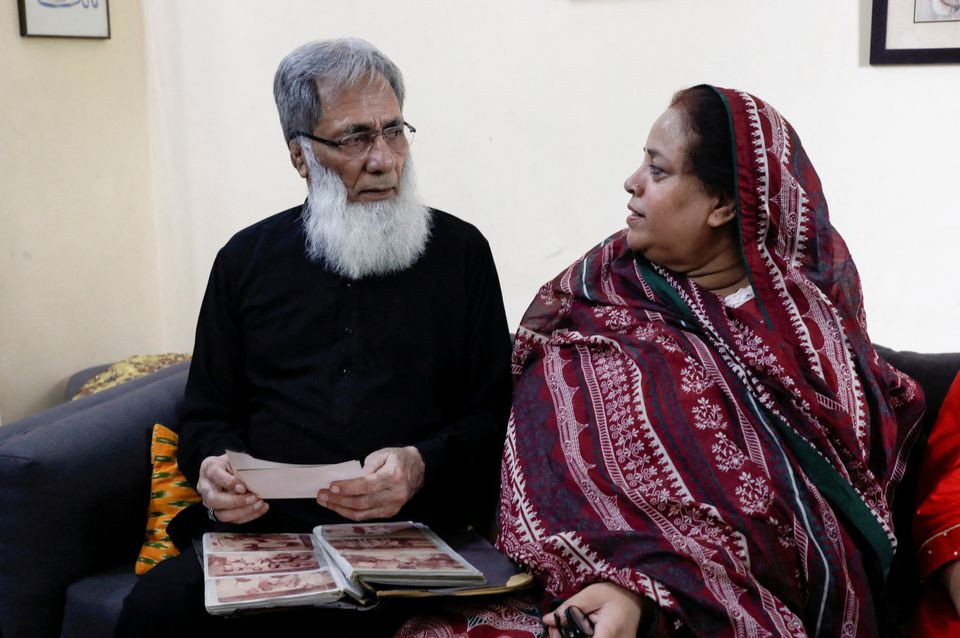 ali hassan baqai 76 whose family was divided by the partition speaks with his wife shaistan ali as they go through the family picture album at home in karachi photo reuters