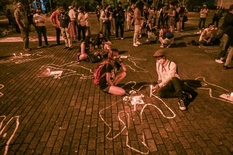 people light candles during a protest against violence and the recent massacres in the country in medellin colombia on september 4 2020 afp