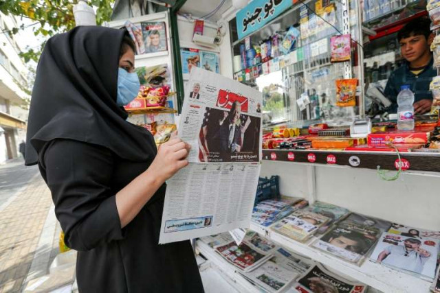 a woman in iran s capital tehran reads the shargh newspaper on sunday where the us general election is a top story afp