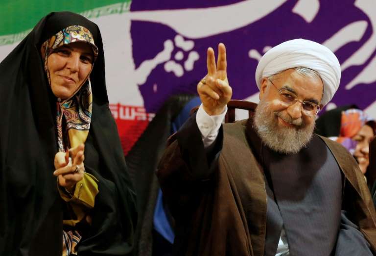 in this file photo taken on may 9 2017 iranian president and presidential candidate hassan rouhani gestures during a campaign rally in tehran flanked by vice president for women s affairs shahindokht molaverdi afp