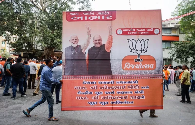 bjp supporters carry a hoarding in ahmedabad india december 3 2023 photo reuters bjp supporters carry a hoarding in ahmedabad india december 3 2023 photo reuters
