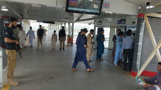 men walking into a peshawar brt station photo express men walking into a peshawar brt station photo express
