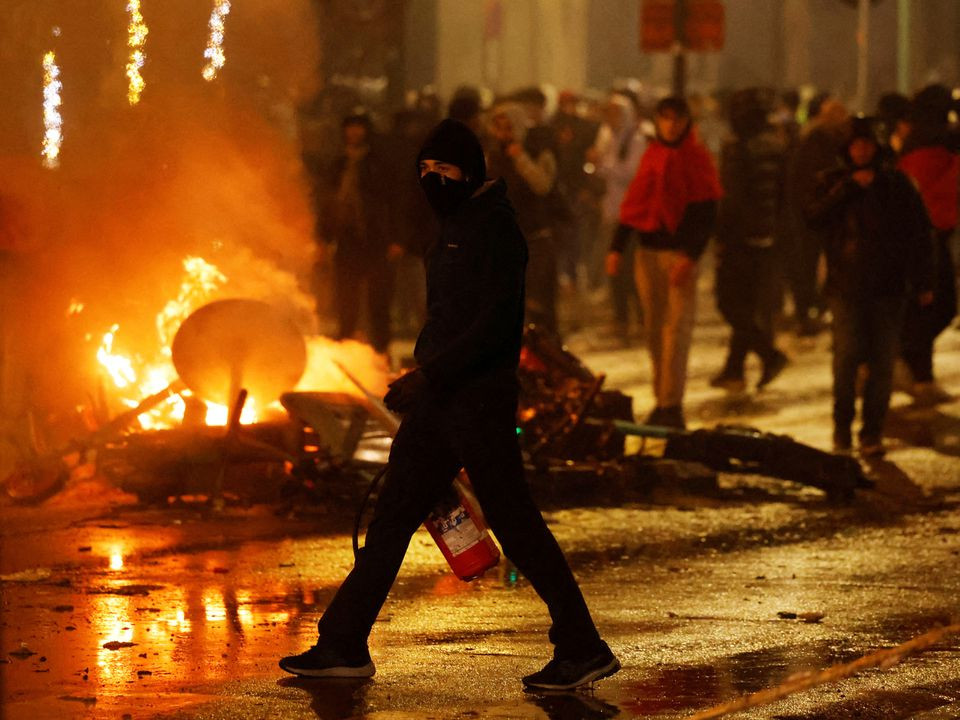 clashes in brussels after the world cup football match between belgium and morocco   brussels belgium   november 27 2022 a man with his face covered and a fire extinguisher is seen during clashes after the world cup match between belgium and morocco reuters yves herman