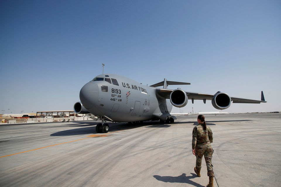 a us military officer walks towards a us air force plane at al udeid airbase in doha qatar september 4 2021 reuters