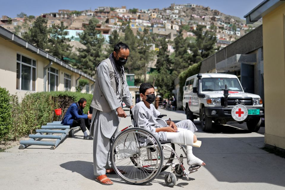 ahmad zia 17 who lost his leg in a magnetic mine in a car is seen with his uncle at the red cross rehabilitation center in kabul afghanistan april 9 2022 reuters