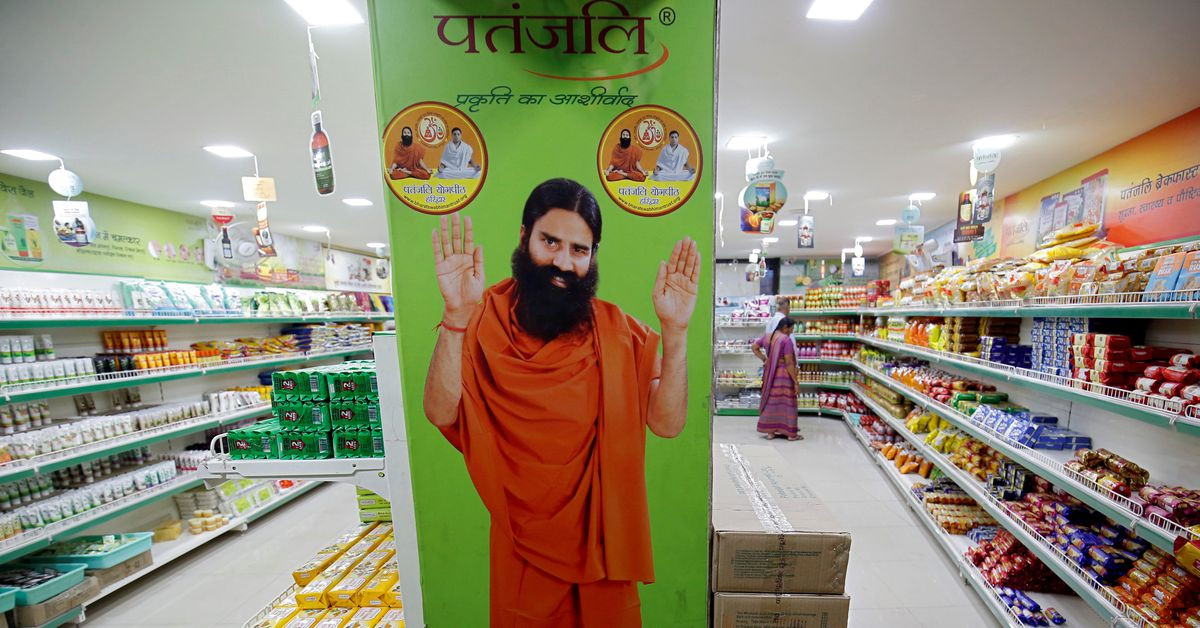 a hoarding with an image of baba ramdev is seen inside a patanjali store in ahmedabad india march 28 2019 photo reuters