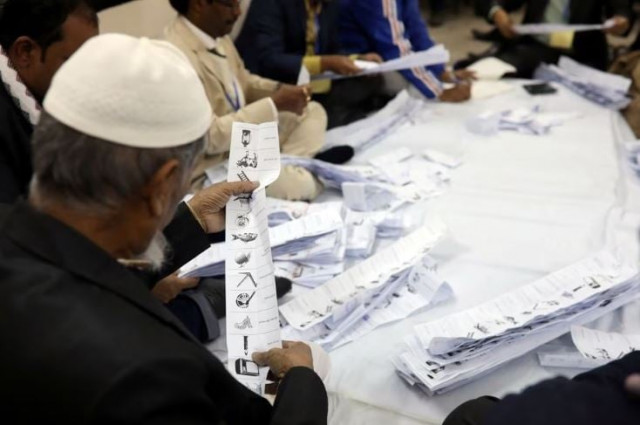 a presiding officer counts votes at a voting center after the session has ended in dhaka bangladesh december 30 2018 photo reuters a presiding officer counts votes at a voting center after the session has ended in dhaka bangladesh december 30 2018 photo reuters