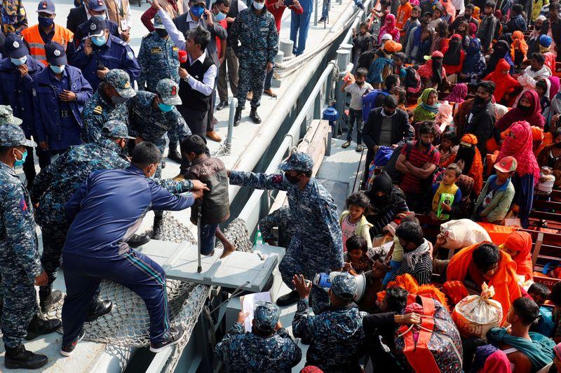 bangladesh navy personnel help a disabled rohingya refugee child to get off from a navy vessel as they arrive at the bhasan char island in noakhali district bangladesh december 29 2020 photo reuters file