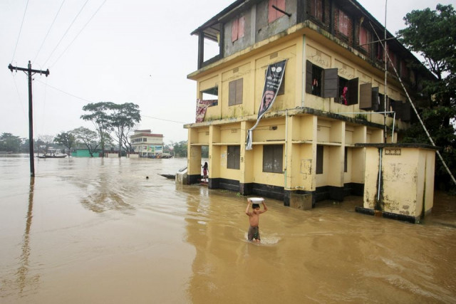 a boy wades through a flooded area during a widespread flood in the northeastern part of the country in sylhet bangladesh june 19 2022 photo reuters a boy wades through a flooded area during a widespread flood in the northeastern part of the country in sylhet bangladesh june 19 2022 photo reuters