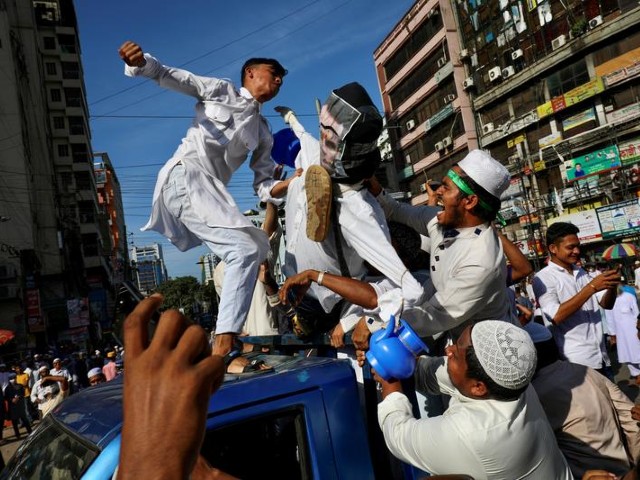 effigy depicting the french president emmanuel macron being hit after friday prayer as they take part in a protest calling for the boycott of french products and denouncing french president emmanuel macron for his islamophobic remarks in dhaka bangladesh october 30 2020 photo reuters