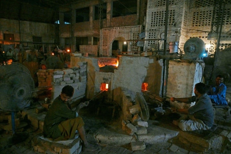 Labourers work at a glass bangle factory in Hyderabad, March 31, 2024. PHOTO: AFP