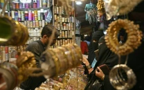 customers buy bangles at a shop photo afp