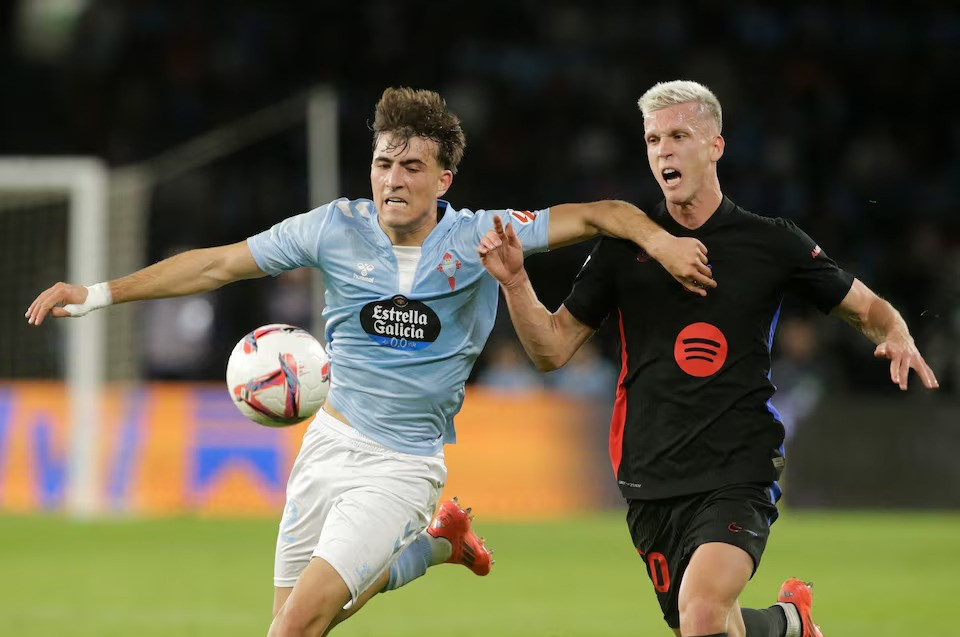 celta vigo s javi rodriguez in action with fc barcelona s dani olmo during laliga match between celta vigo v fc barcelona at estadio de balaidos vigo spain on november 23 2024 photo reuters