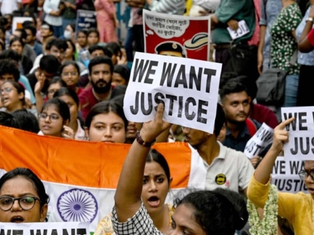 junior doctors carry india s national flag and hold placards during a protest to demand justice over the rape and murder of a doctor in early august in kolkata on monday photo afp