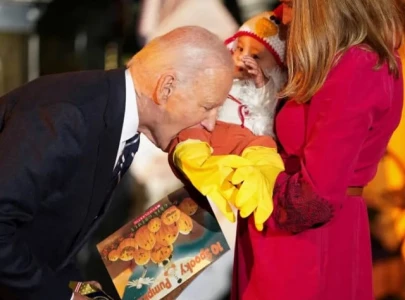 internet reacts as joe biden s baby biting photos stir debate somebody give him an ice cream
