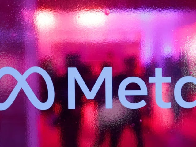 people walk behind a logo of meta platforms company during a conference in mumbai india september 20 2023 photo reuters