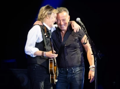 paul mccartney teases bruce springsteen as he presents top songwriting honor at ivor novello awards