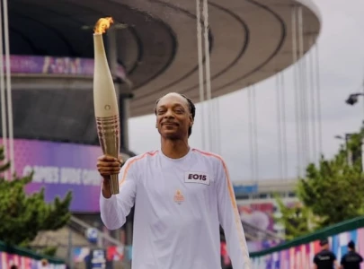 snoop dogg carries olympic torch in paris inspires a wave of hilarious memes