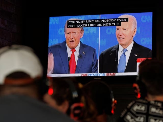 people watch the first presidential debate between u s president joe biden and republican candidate former president donald trump from a tavern in san diego california u s june 27 2024 photo reuters