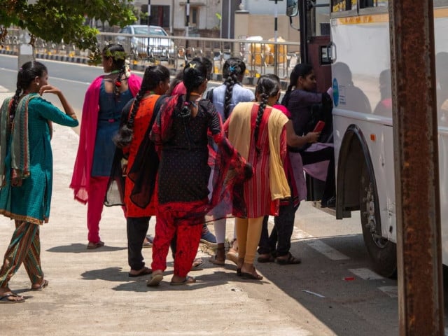 women board a foxconn factory bus near the village of molachur tamil nadu india april 1 2024 photo reuters