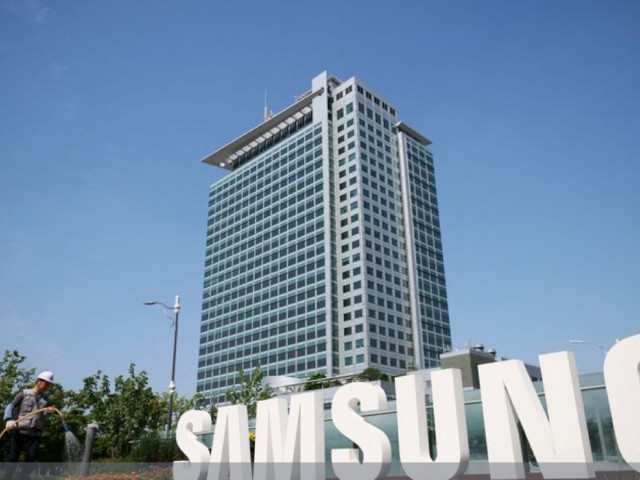 a worker waters a flower bed next to the logo of samsung electronics during a media tour at samsung electronics headquarters in suwon south korea june 13 2023 photo reuters