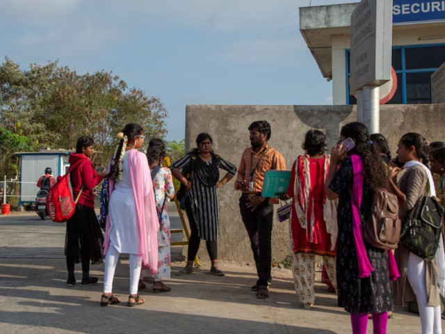 job aspirants talk with a hiring agent outside the foxconn factory where workers assemble iphones for apple in sriperumbudur near chennai india april 1 2024 photot reuters