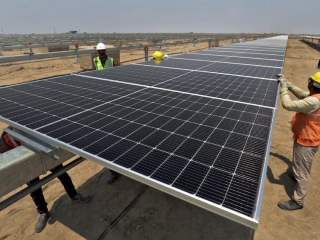 workers install solar panels at the khavda renewable energy park of adani green energy ltd agel in khavda india april 12 2024 photo reuters