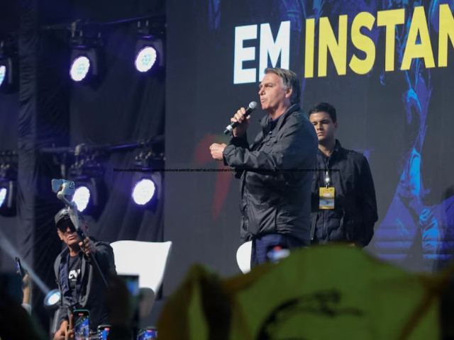 brazil s former president jair bolsonaro speaks while a person holds a gadsden flag during the cpac conservative political action conference in balneario camboriu santa catarina state brazil july 6 2024 photo reuters