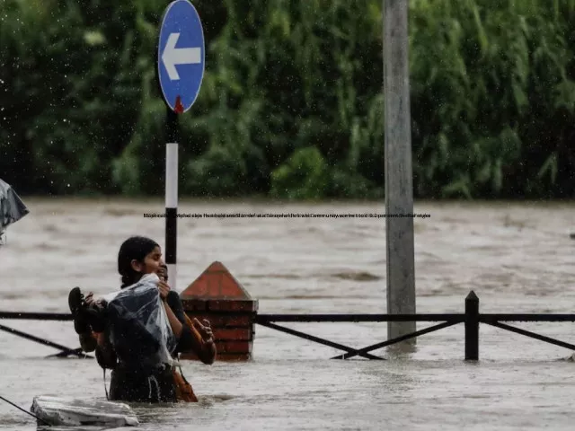 a woman carrying her belongings wades through a flooded road along the bank of overflowing bagmati river following heavy rains in kathmandu nepal july 6 2024 photo reuters a woman carrying her belongings wades through a flooded road along the bank of overflowing bagmati river following heavy rains in kathmandu nepal july 6 2024 photo reuters