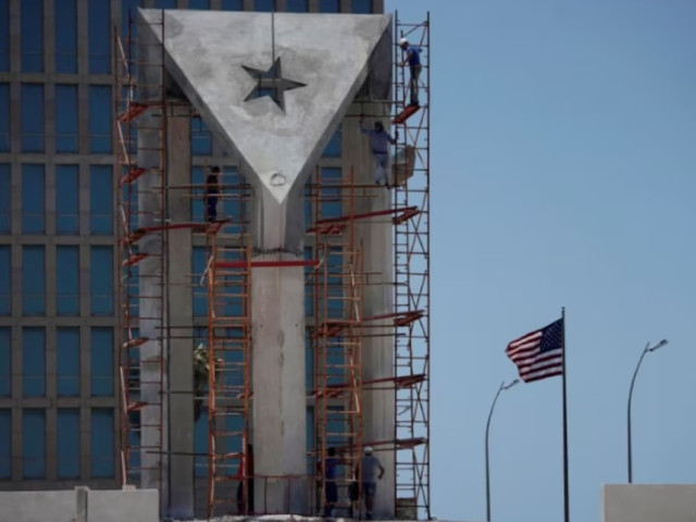 men work in a monument in front of the us embassy in havana cuba may 25 2021 photo reuters men work in a monument in front of the us embassy in havana cuba may 25 2021 photo reuters