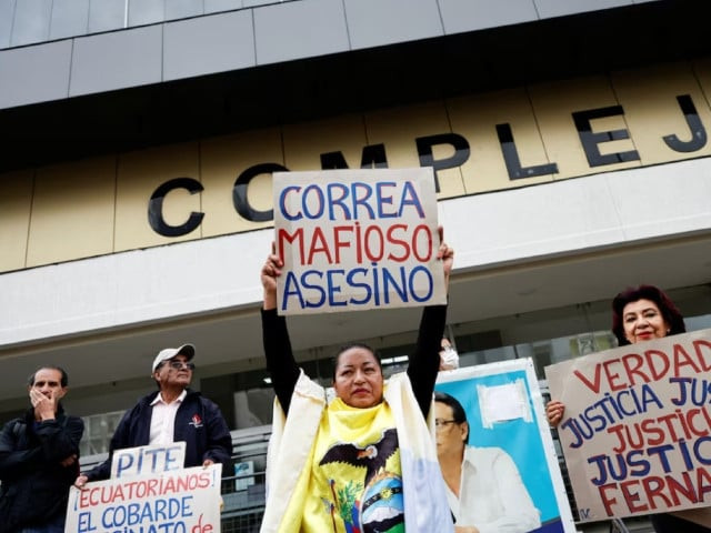 a woman holds a sign reading correa mafia murderer during a demonstration outside a court that handed down prison sentences for five people found guilty of murdering presidential candidate fernando villavicencio in quito ecuador july 12 2024 photo reuters a woman holds a sign reading correa mafia murderer during a demonstration outside a court that handed down prison sentences for five people found guilty of murdering presidential candidate fernando villavicencio in quito ecuador july 12 2024 photo reuters