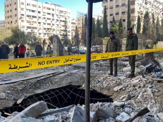 police officers stand on the rubble of a damaged building at the site of a rocket attack in central damascus kafr sousa neighborhood syria february 19 2023 photo reuters police officers stand on the rubble of a damaged building at the site of a rocket attack in central damascus kafr sousa neighborhood syria february 19 2023 photo reuters