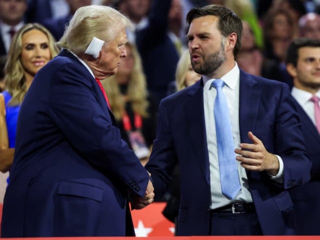 republican presidential nominee and former u s president donald trump greets republican vice presidential nominee j d vance as he attends day 1 of the republican national convention rnc at the fiserv forum in milwaukee wisconsin us july 15 2024 photo reuter