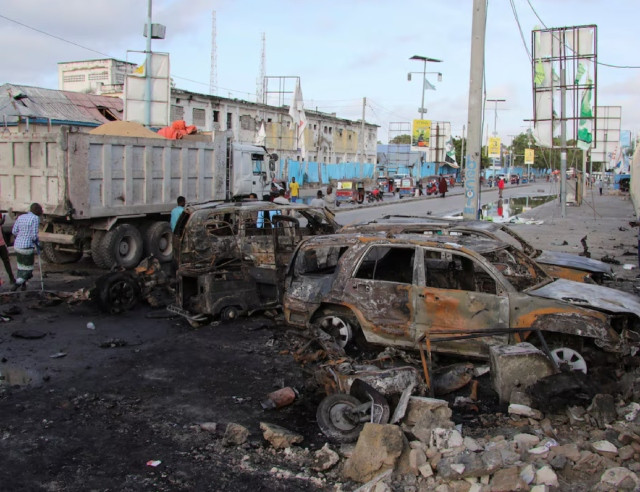 people gather near the wreckages of vehicles destroyed at the scene of an explosion outside a restaurant where patrons were watching the final of the euro 2024 football tournament on tv in bondhere district of mogadishu somalia july 15 2024 photo reuters