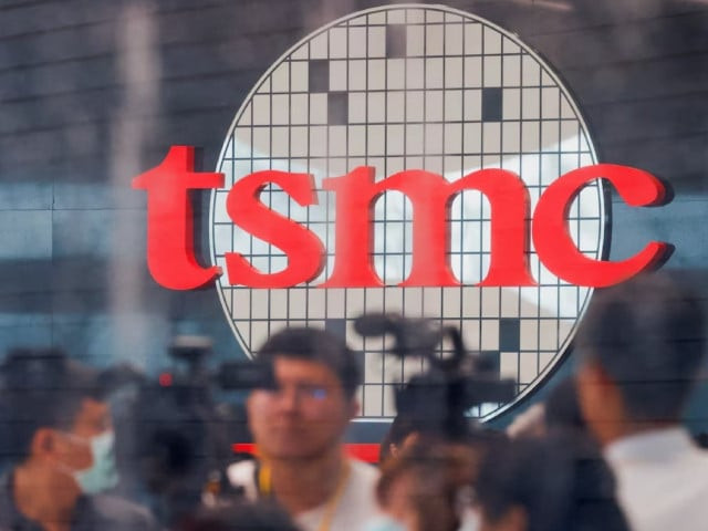taiwan semiconductor manufacturing company s tsmc logo is seen while people attend the opening of the tsmc global r d center in hsinchu taiwan july 28 2023 photo reuters taiwan semiconductor manufacturing company s tsmc logo is seen while people attend the opening of the tsmc global r d center in hsinchu taiwan july 28 2023 photo reuters