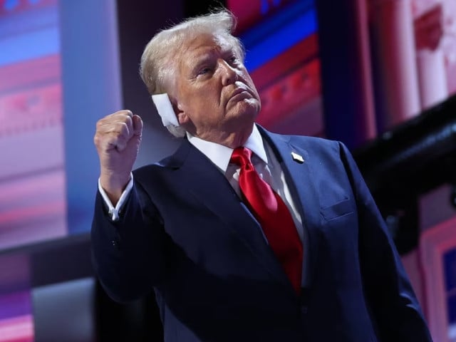 republican presidential nominee and former u s president donald trump raises his fist from the stage on day 4 of the republican national convention rnc at the fiserv forum in milwaukee wisconsin us july 18 2024 photo reuters