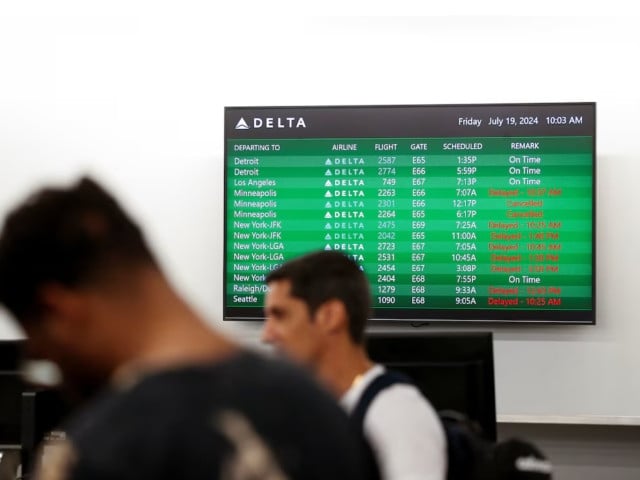 passengers wait in line at ticket counters after airlines grounded flights due to a worldwide tech outage caused by an update to crowdstrike s falcon sensor software which crashed microsoft windows systems at tampa international airport in tampa florida us july 19 2024 photo reuters