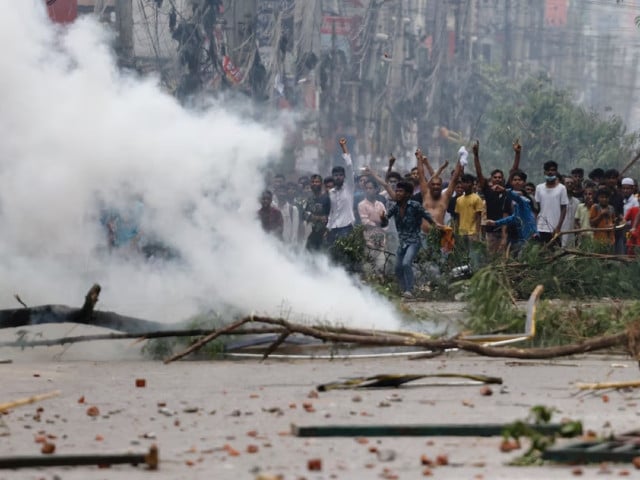 people gesture near smoke as protesters clash with border guard bangladesh bgb and the police outside the state owned bangladesh television as violence erupts across the country after anti quota protests by students in dhaka bangladesh july 19 2024 photo reuters