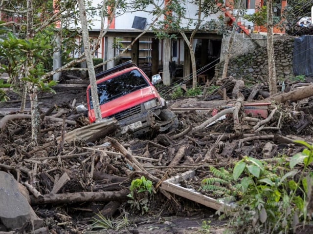a damaged car is seen in an area affected by heavy rain brought flash floods and landslides in tanah datar west sumatra province indonesia may 12 2024 in this photo taken by antara foto antara foto sigit putra via photo reuters