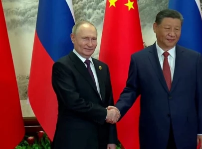 xi lauds china russia ties as putin lands in beijing