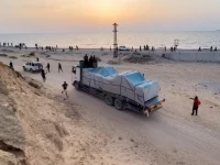 truck carrying aid delivered into gaza via a u s  built pier moves as seen from central gaza strip in this still image taken from a video may 17 2024 photo reuters