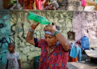 a woman pours water on her head after filling her containers with drinking water from a municipal tanker on a hot summer day in new delhi india may 21 2024 photo reuters